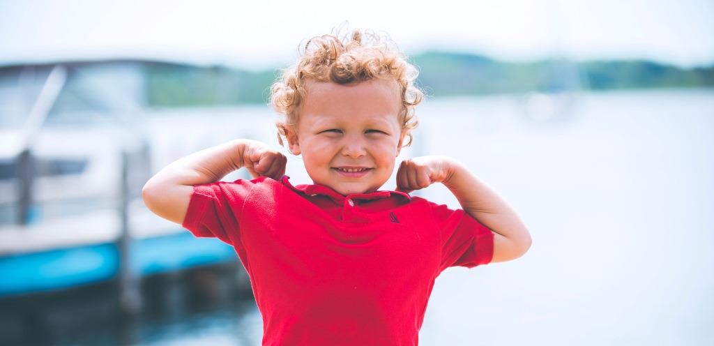 Kid Making Muscles